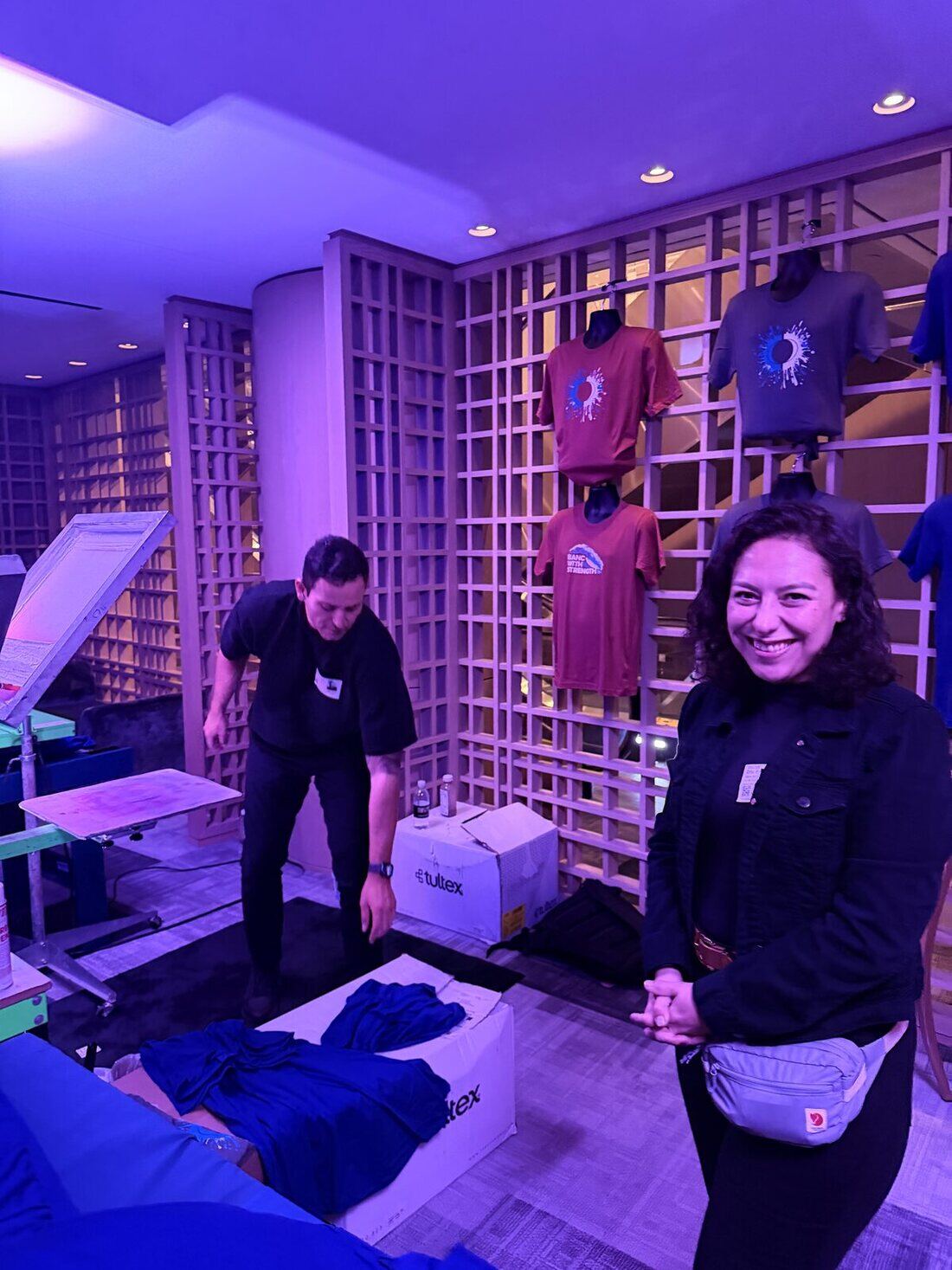 Merch Troop crew loading in and building a print station at an event venue